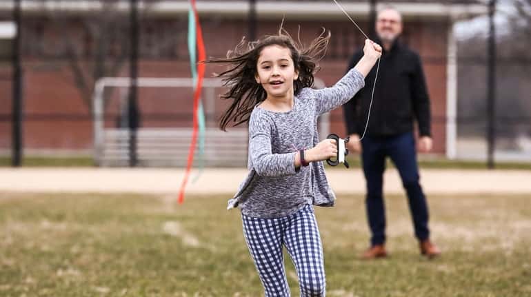 Norah Wouters Almeida, 8, of Locust Valley, catches air with...