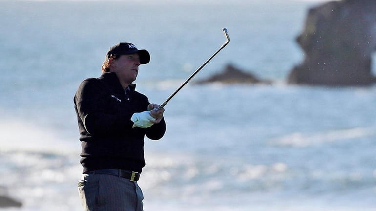 In this Feb. 11, 2019, file photo, Phil Mickelson hits...