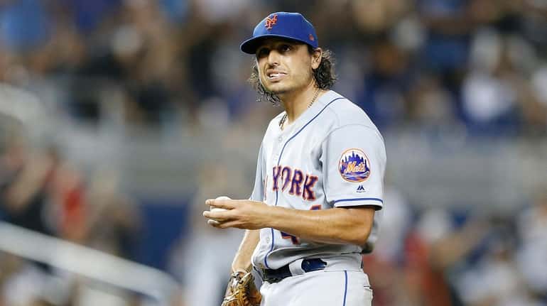 Jason Vargas of the New York Mets reacts after giving...