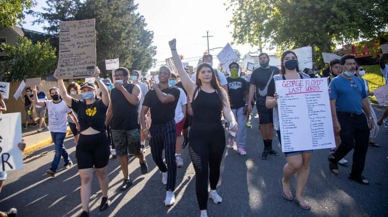 Protesters demand justice for George Floyd during a march last month in...