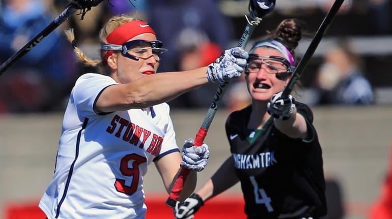 Stony Brook's Emma Schait #9 scores a goal while defended...