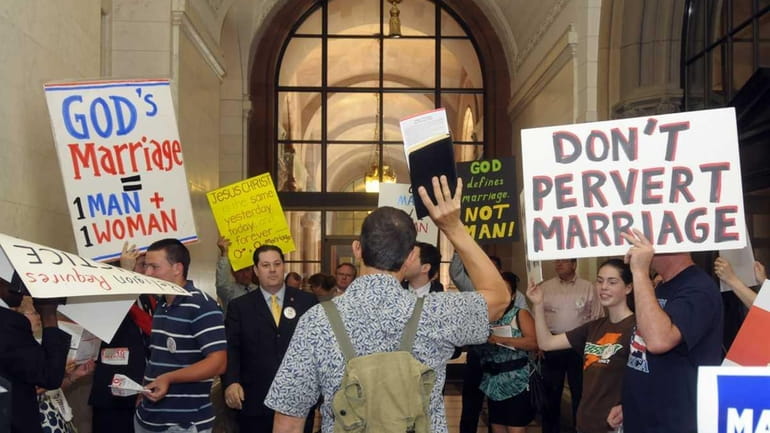Protesters for and against the same-sex marriage bill protest in...