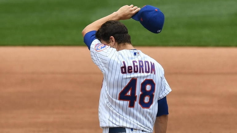 New York Mets starting pitcher Jacob deGrom stands on the...