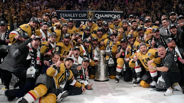 Members of the Vegas Golden Knights pose with the Stanley...