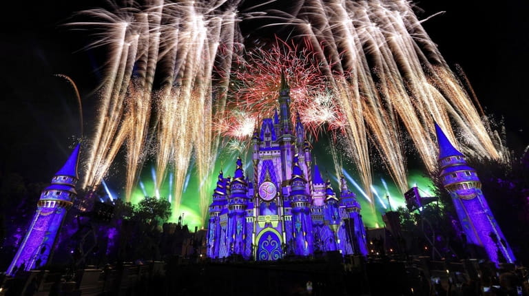 Fireworks illuminate Cinderella Castle at the Magic Kingdom marking the...