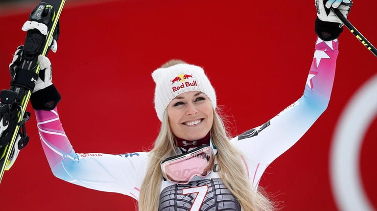 Lindsey Vonn celebrates on the podium after winning an alpine...