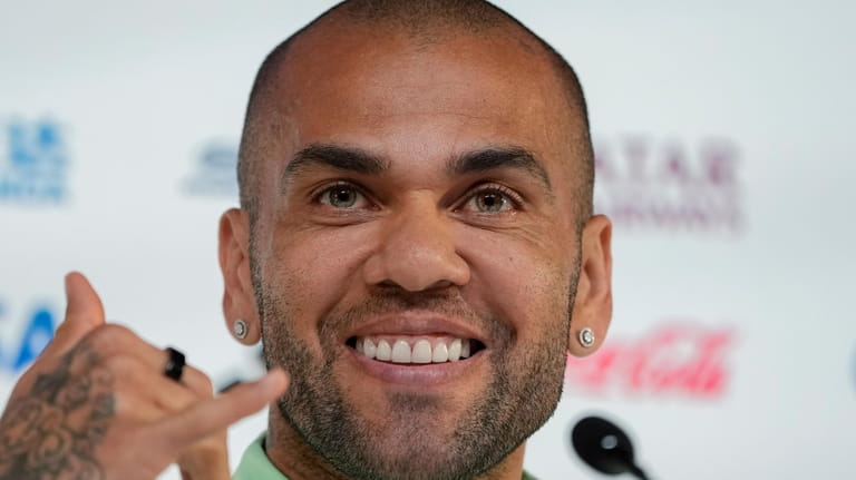 Brazil's Dani Alves smiles during a press conference on the...