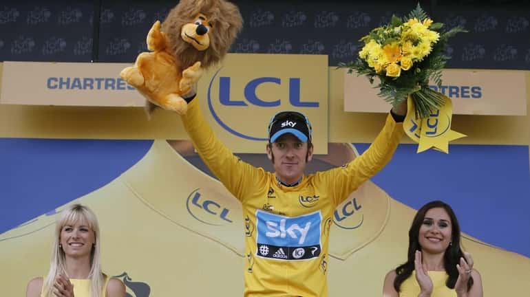 Bradley Wiggins of Britain, wearing the overall leader's yellow jersey,...
