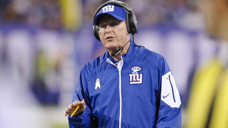 New York Giants head coach Tom Coughlin talks to an...