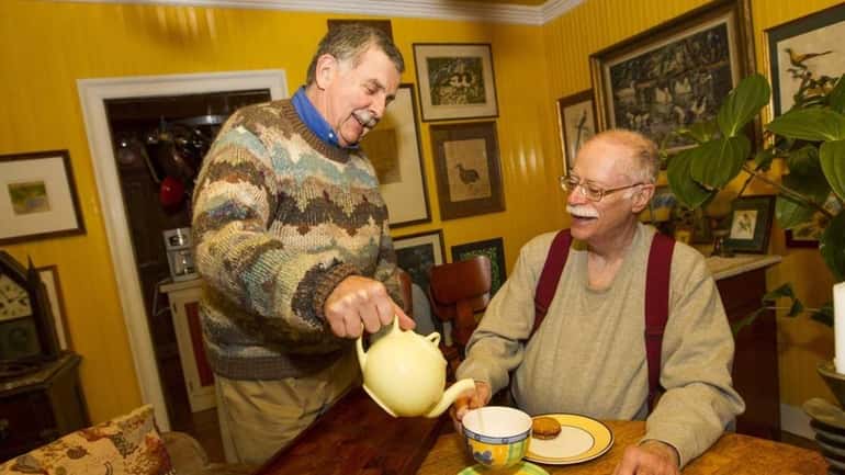 Tim Smulian (left) serves tea tea to Edwin Blesch at...