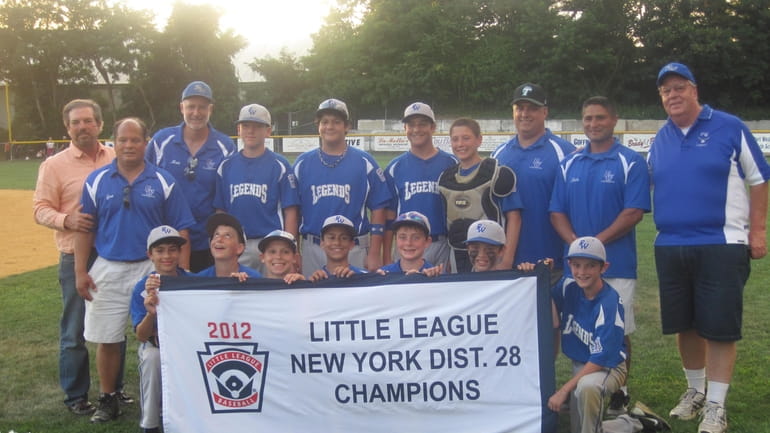 Port Washington 12-year-olds hold their championship banner after winning the...