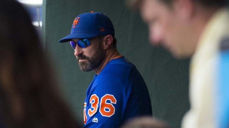 Manager Mickey Callaway of the Mets looks on in the dugout...