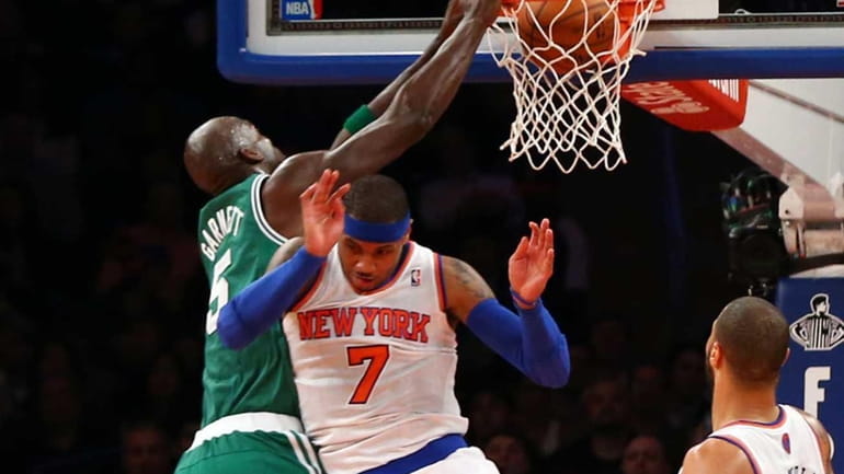 Kevin Garnett of the Boston Celtics dunks over Carmelo Anthony....