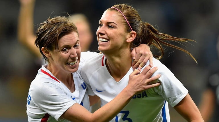 Alex Morgan #13 of the United States and teammate Meghan...
