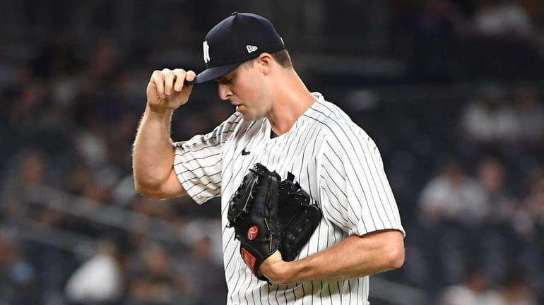 Yankees relief pitcher Clay Holmes reacts during the ninth inning...