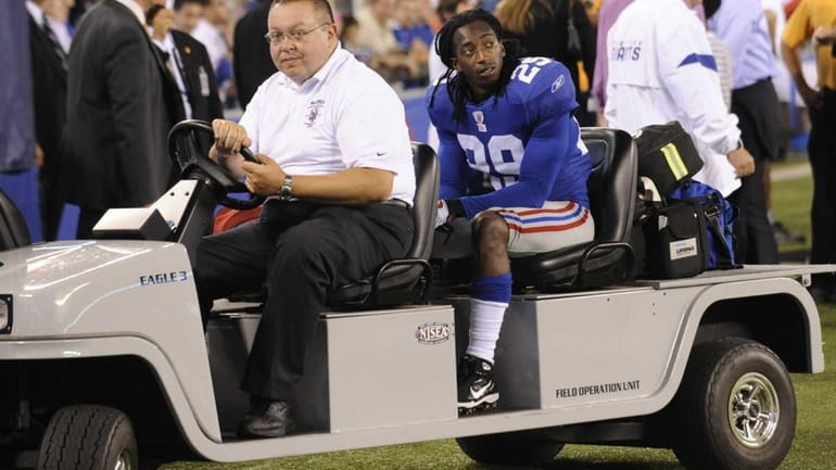 New York Giants running back Brian Witherspoon is taken off...