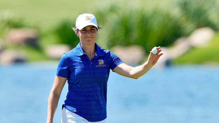 San Jose State golfer Lucia Lopez-Ortega waves after her shot...