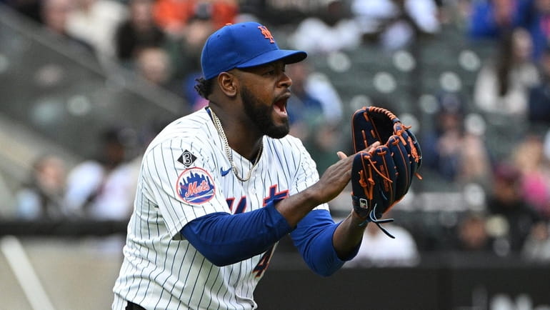 Mets starting pitcher Luis Severino reacts to a play against...