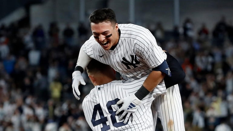 Anthony Volpe #11 of the Yankees celebrates his tenth inning game...