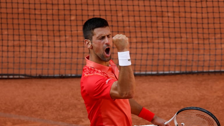Serbia's Novak Djokovic celebrates winning his quarterfinal match of the...
