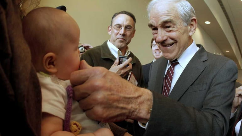 Republican presidential candidate Ron Paul of Texas greets 3-month-old Heidi...
