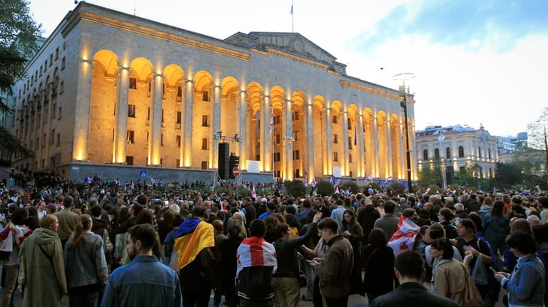 Protestors gather outside the parliament building in Tbilisi, Georgia, on...