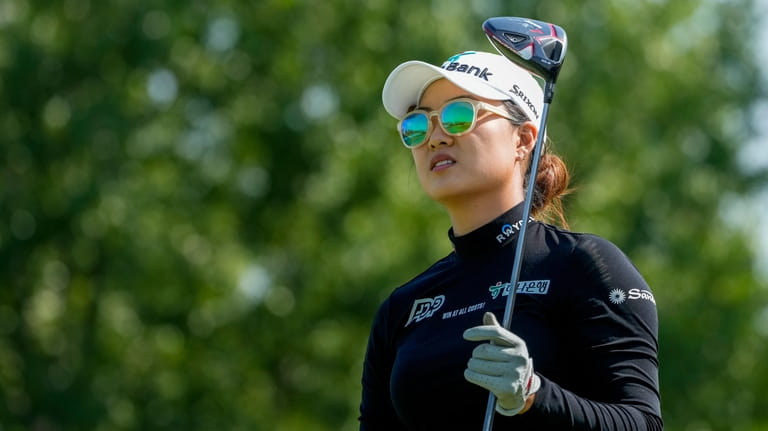 Minjee Lee, of Australia, watches her shot off the 18th...