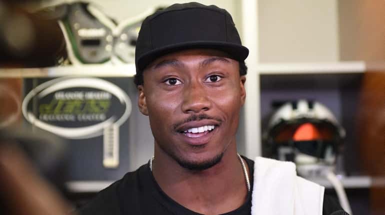 Jets wide receiver Brandon Marshall answers questions from reporters during...