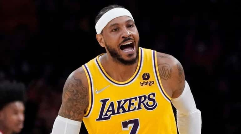 Lakers forward Carmelo Anthony reacts after scoring against the Rockets during...