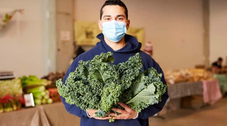 Danny Lopez with curly kale from 4 E Green Farm...