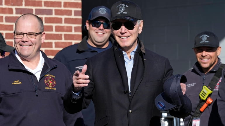 President Joe Biden, center, standing next to Nantucket Fire Department...