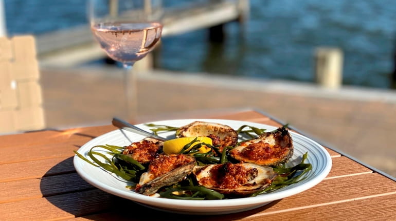 Grilled oysters with a glass of rosé at View in...