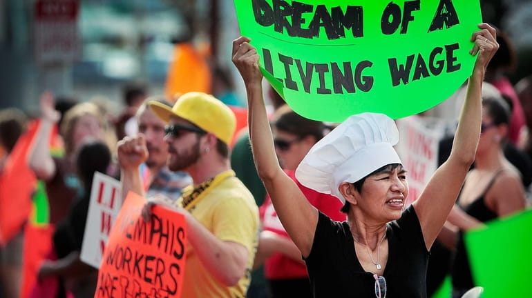 Christina Condori joins a crowd of fast-food workers and their...