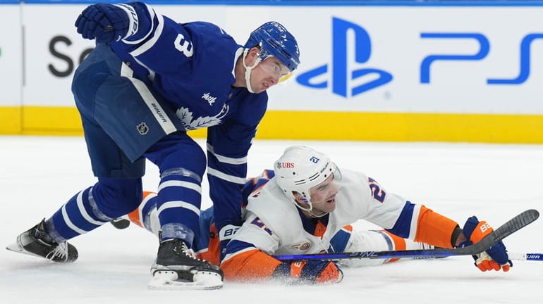 Toronto Maple Leafs defenseman Justin Holl (3) knocks New York...