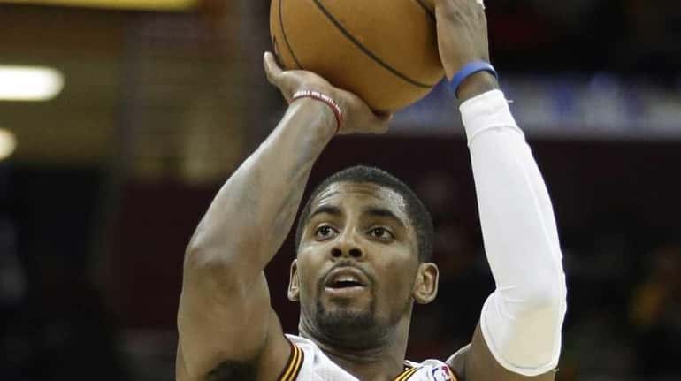 Cleveland Cavaliers' Kyrie Irving shoots a 3-point shot against the...