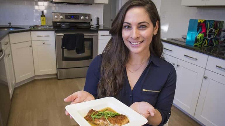 Amanda Gershman with her pan-seared salmon in lemon broth topped...