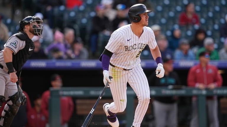 Colorado Rockies' Nolan Jones flies out with the bases loaded...