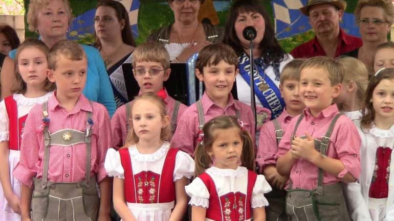 Members of the Die Erste Gottscheer Tanzgruppe children's group wait...