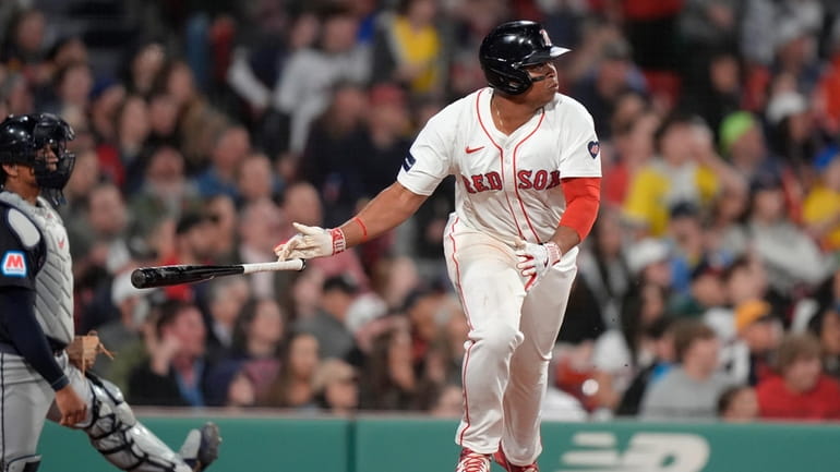 Boston Red Sox's Rafael Devers drops his bat after hitting...