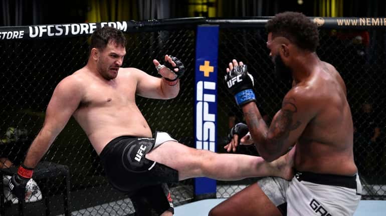 In this handout image provided by UFC, Gian Villante kicks...
