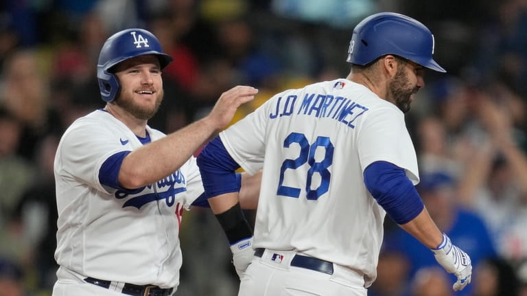 Los Angeles Dodgers' Max Muncy (13) celebrates with designated hitter...
