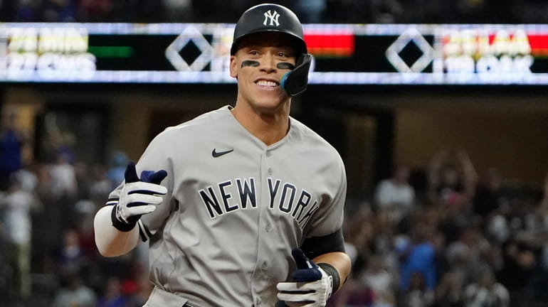 The Yankees’ Aaron Judge rounds the bases after hitting his...