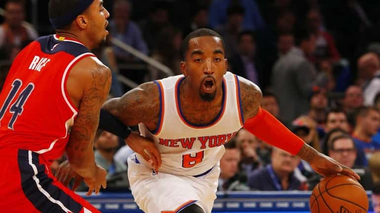 J.R. Smith of the New York Knicks is guarded by...
