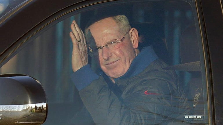 Tom Coughlin waves to photographers as he leaves the New...