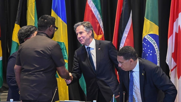 Secretary of State Antony Blinken, center, shakes hands with Guyana's...
