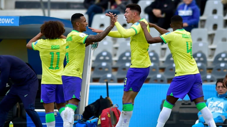 Brazil's Jean Pedroso, second from right, is congratulated after scoring...