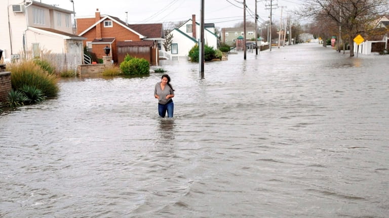 A resident tries to flee through waist-deep waters on Shore...