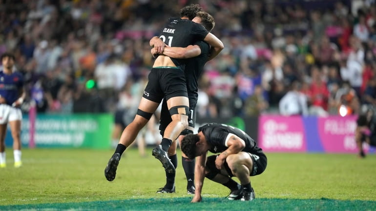 New Zealand's players celebrate after winning the men's final match...