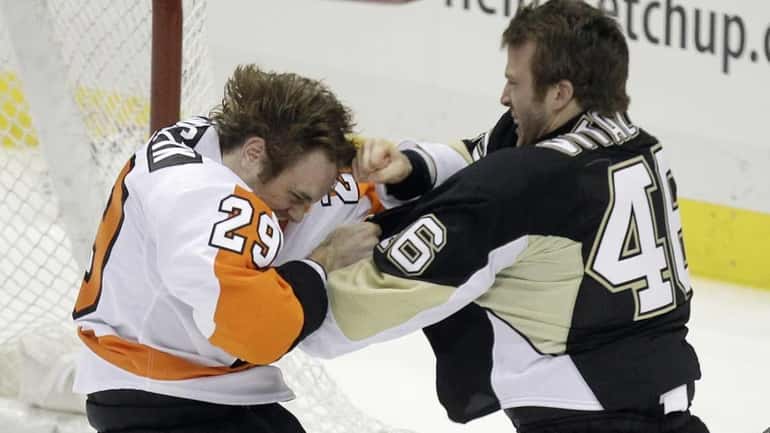 Philadelphia Flyers' Harry Zolnierczyk (29) fights with Pittsburgh Penguins Joe...