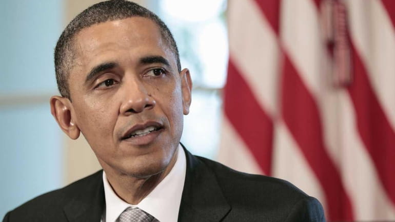 President Barack Obama speaks to members of the media during...